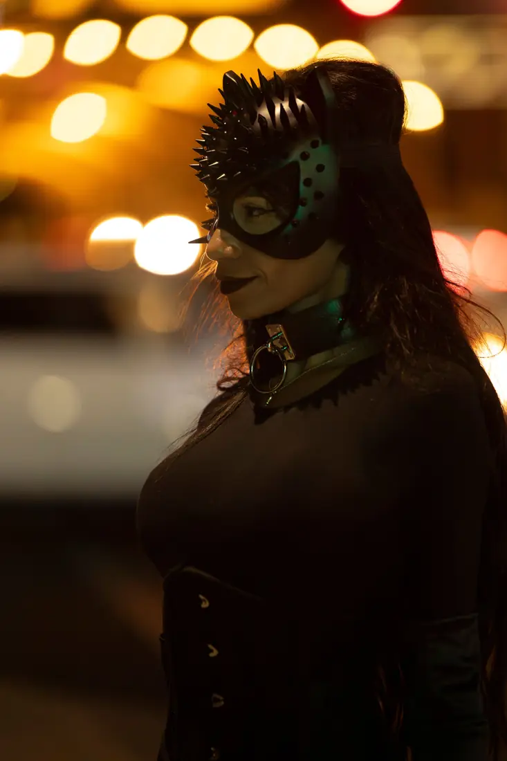 Illustrative stock portrait of a masked woman in an evening setting
