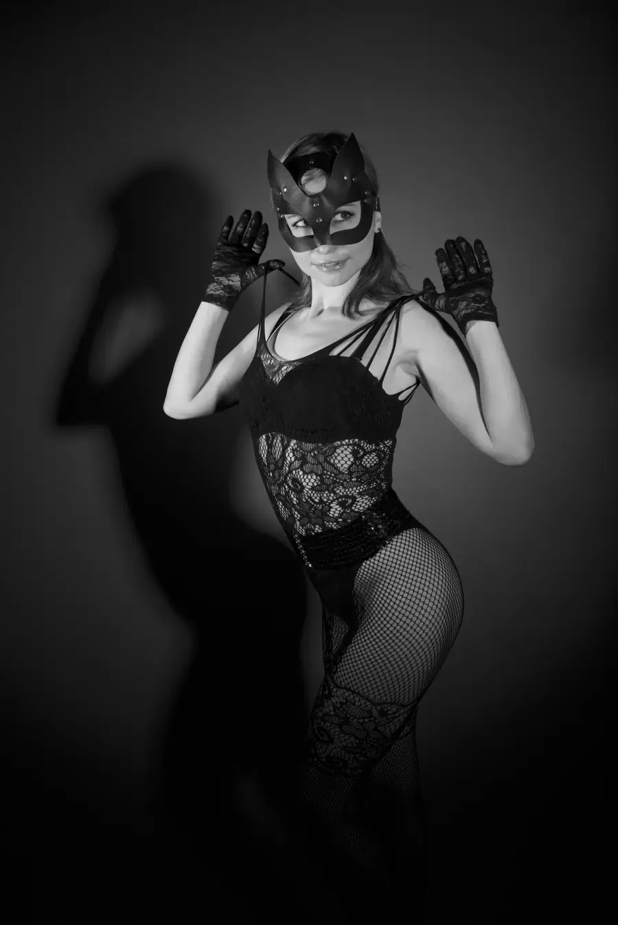 Illustrative black and white stock photograph of a masked woman in dramatic fashion